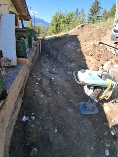 Remblayage et compactage Arrivée du remblayage au sommet du mur du chalet.